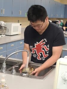 student washing sugar beets